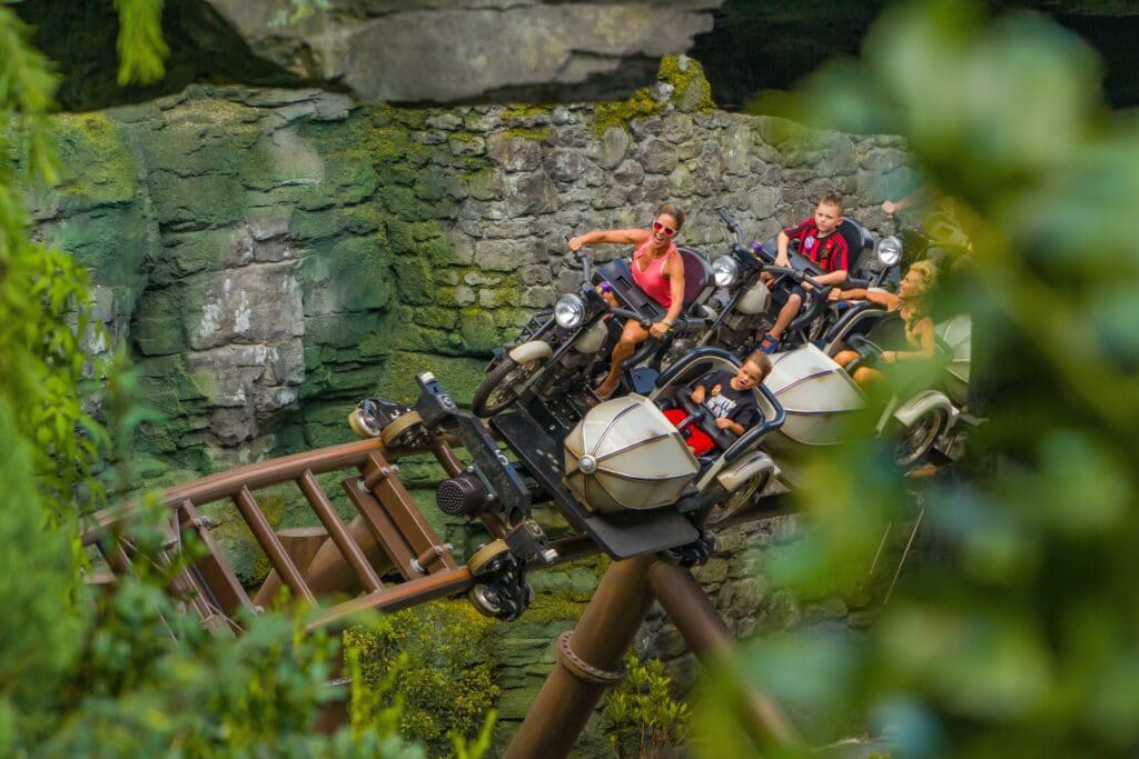 Family on bikes and in sidecars riding Hagrid's Magical Creatures Motorbike Adventure