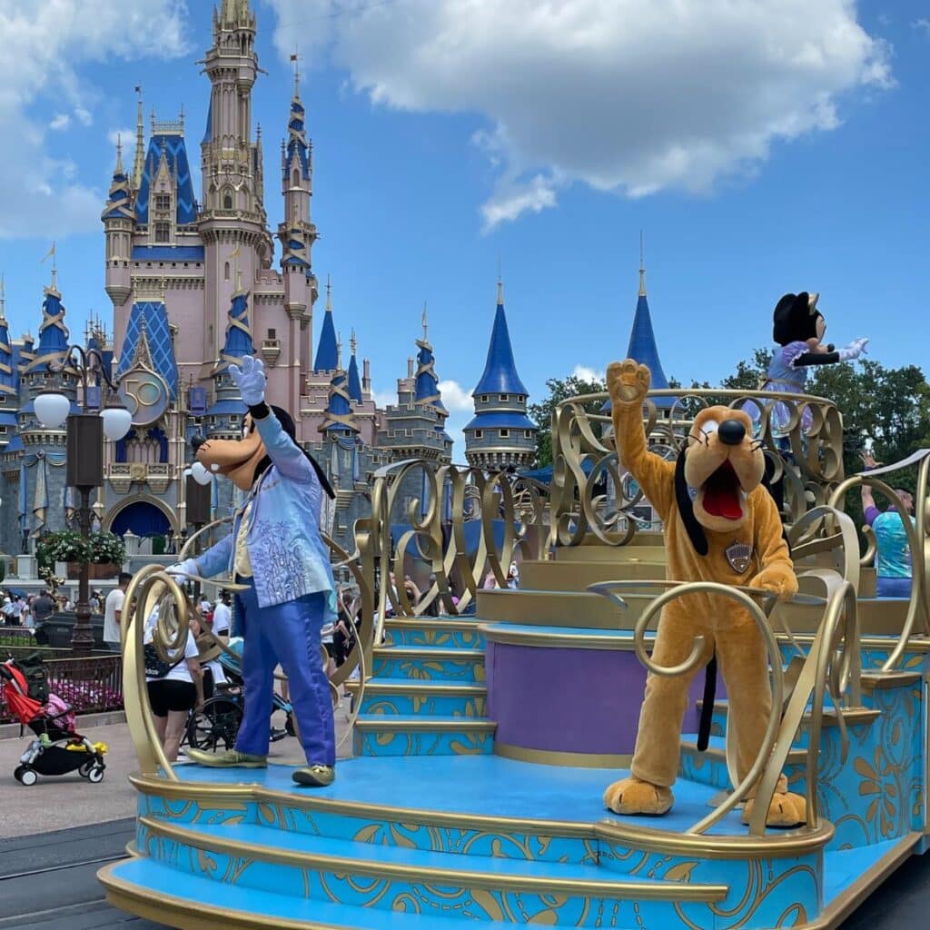 parade at magic kingdom in disney world featuring pluto and goofy