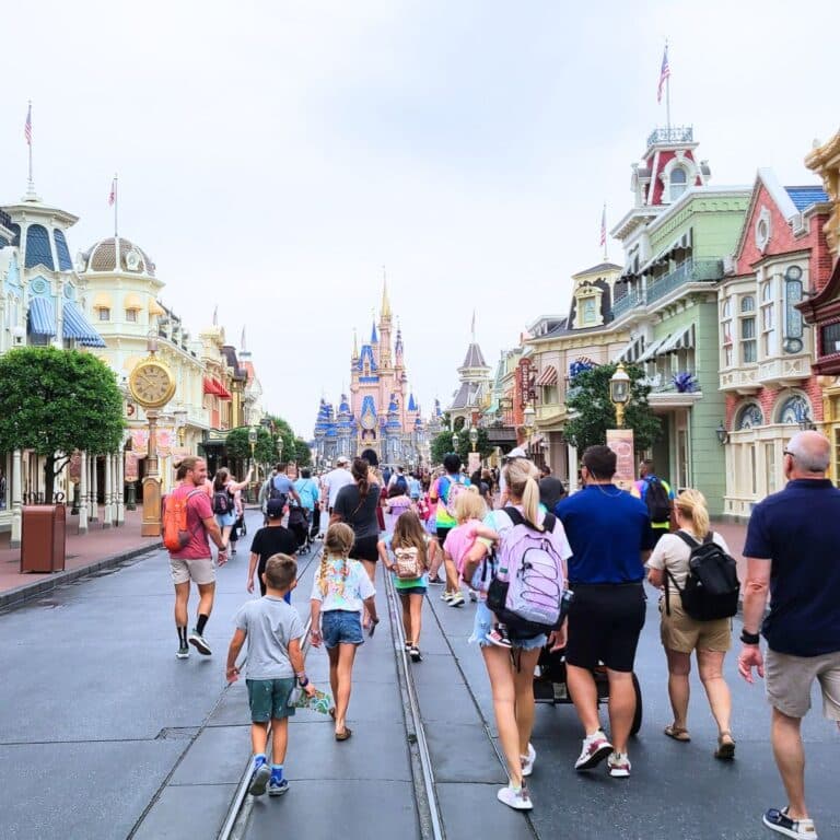 people walking along Main Street USA toward Cinderella's castle at Magic Kingdom