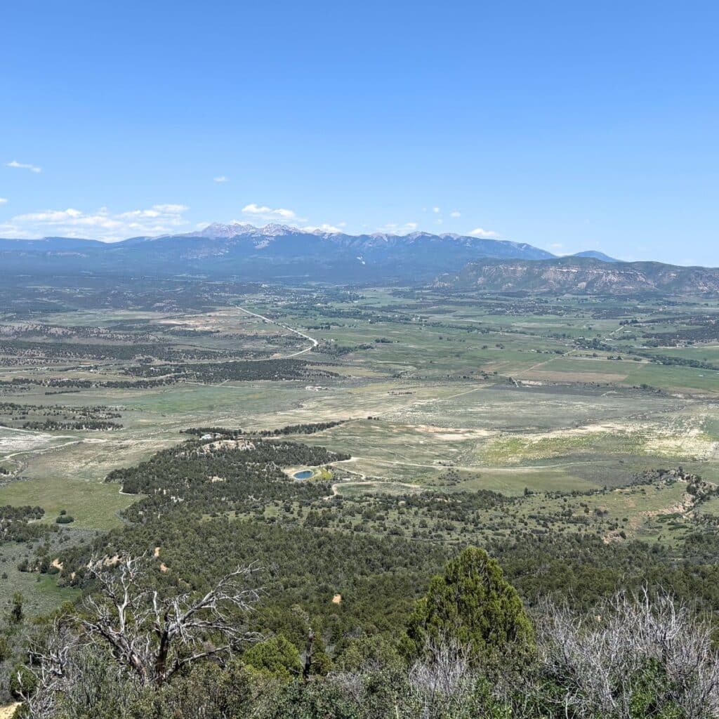 Rocky Mountains in a distance with mesas as seen from Mesa Verde