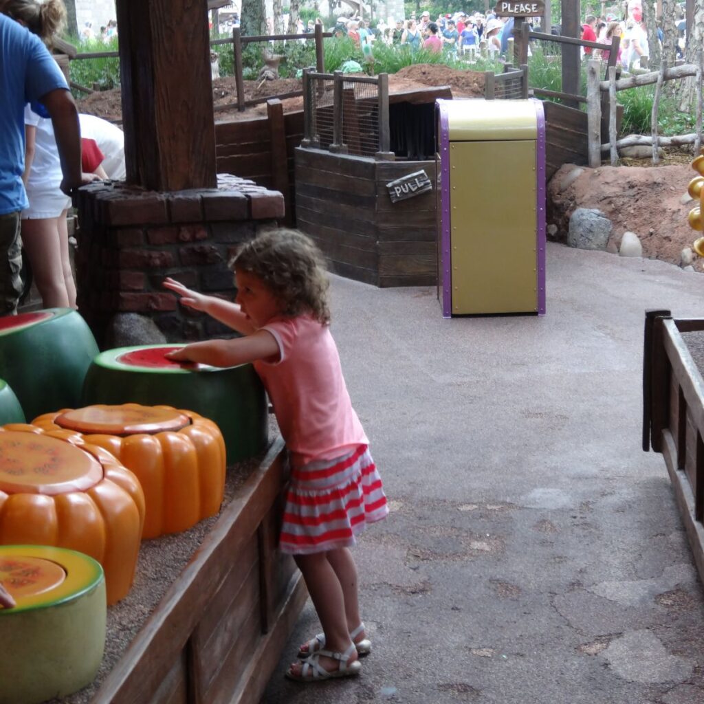child playing in the Winnie the Pooh queue - drums